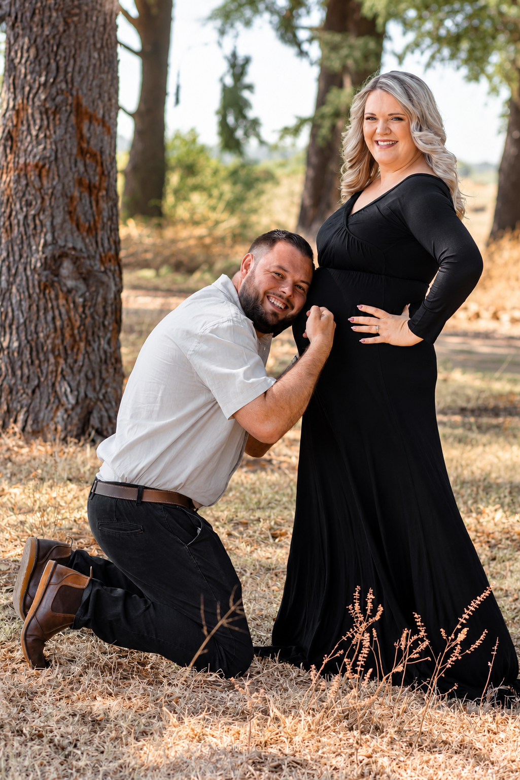 Maternity portrait with a partner beside a tree