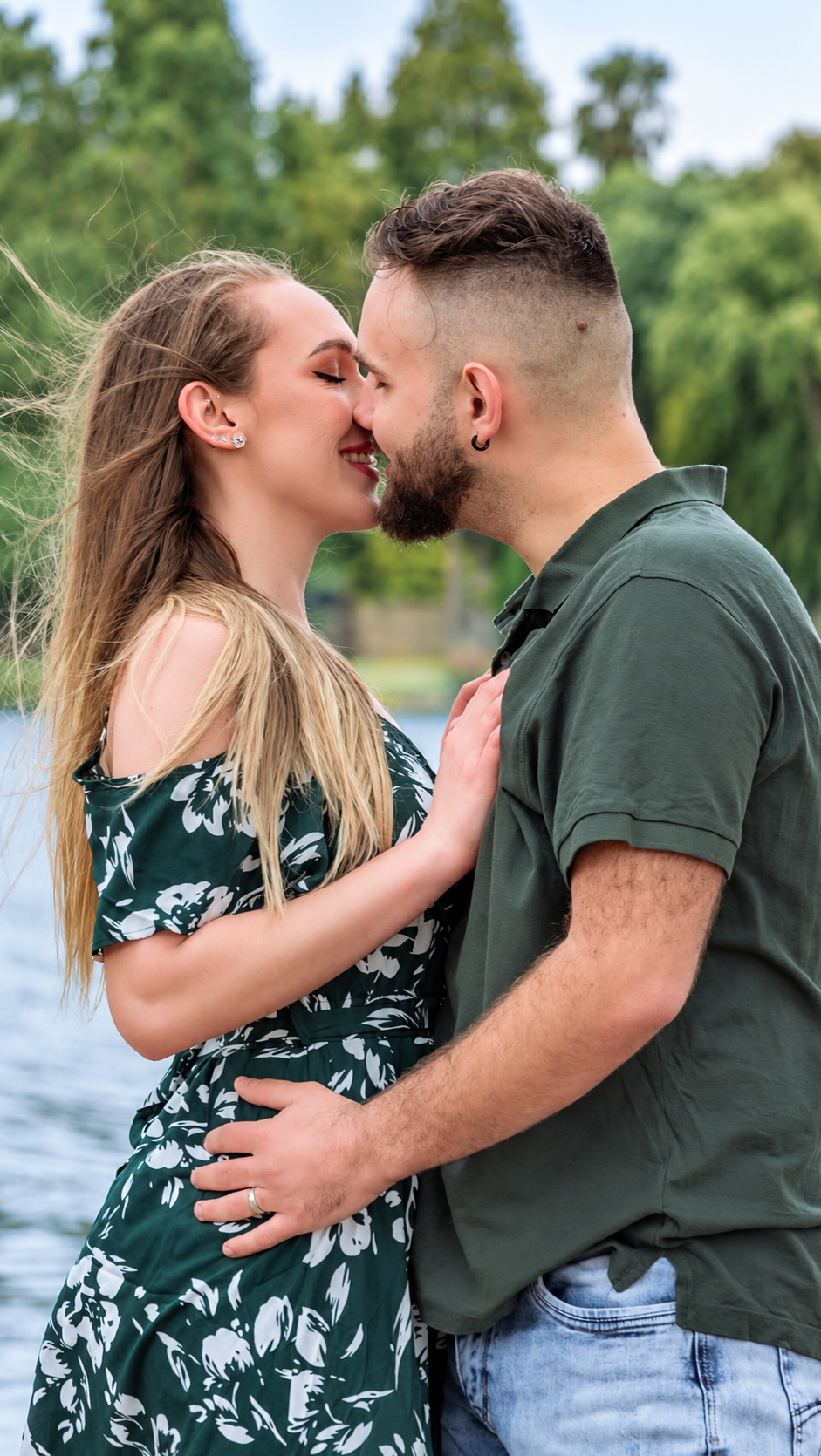 Couple sharing a kiss in a green garden