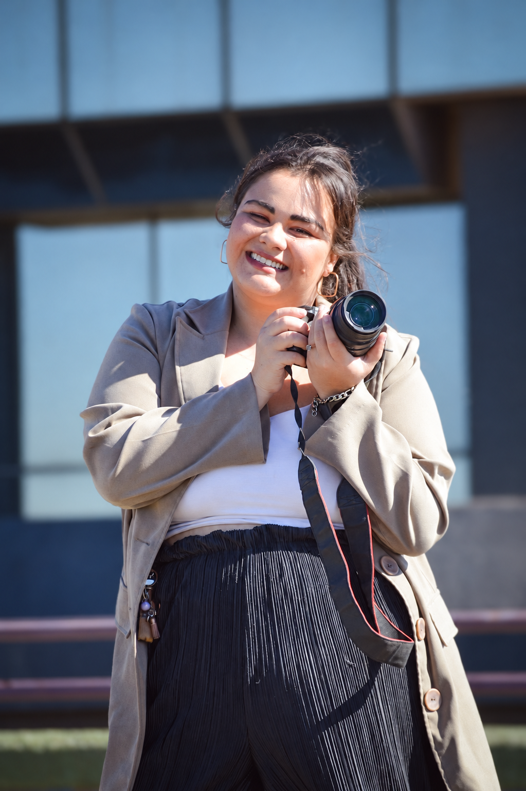 Portrait of Wendy holding her camera outdoors