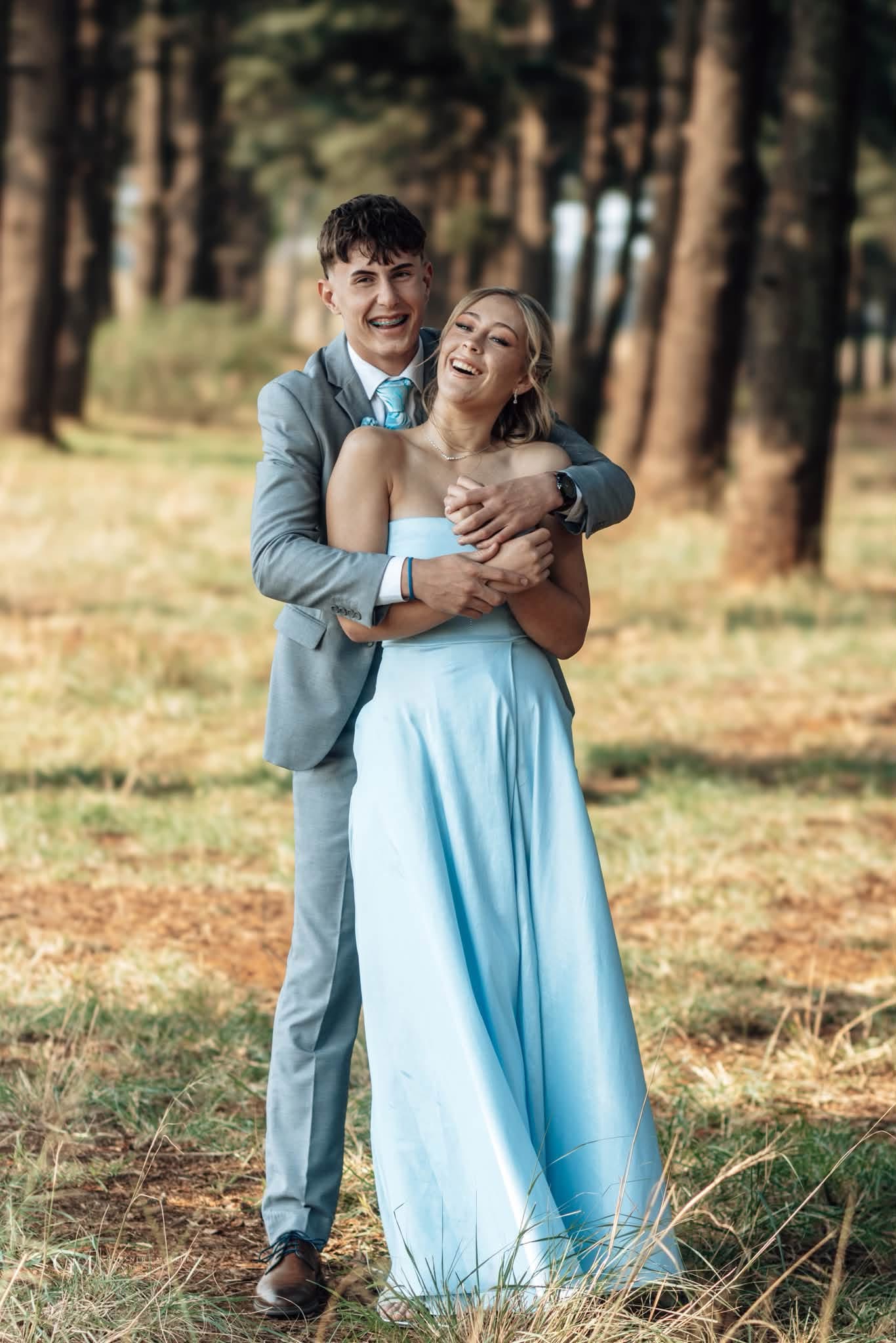 Matric farewell couple laughing in a blue dress and grey suit